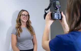 Image of a patient getting her photos taken to start her Invisalign treatment.