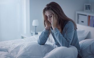 Young female suffering from a headache after a poor sleep