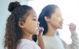 Family brushing their teeth