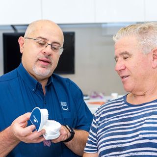 Our Gladstone lead dentist, Dr Fanelli with a patient