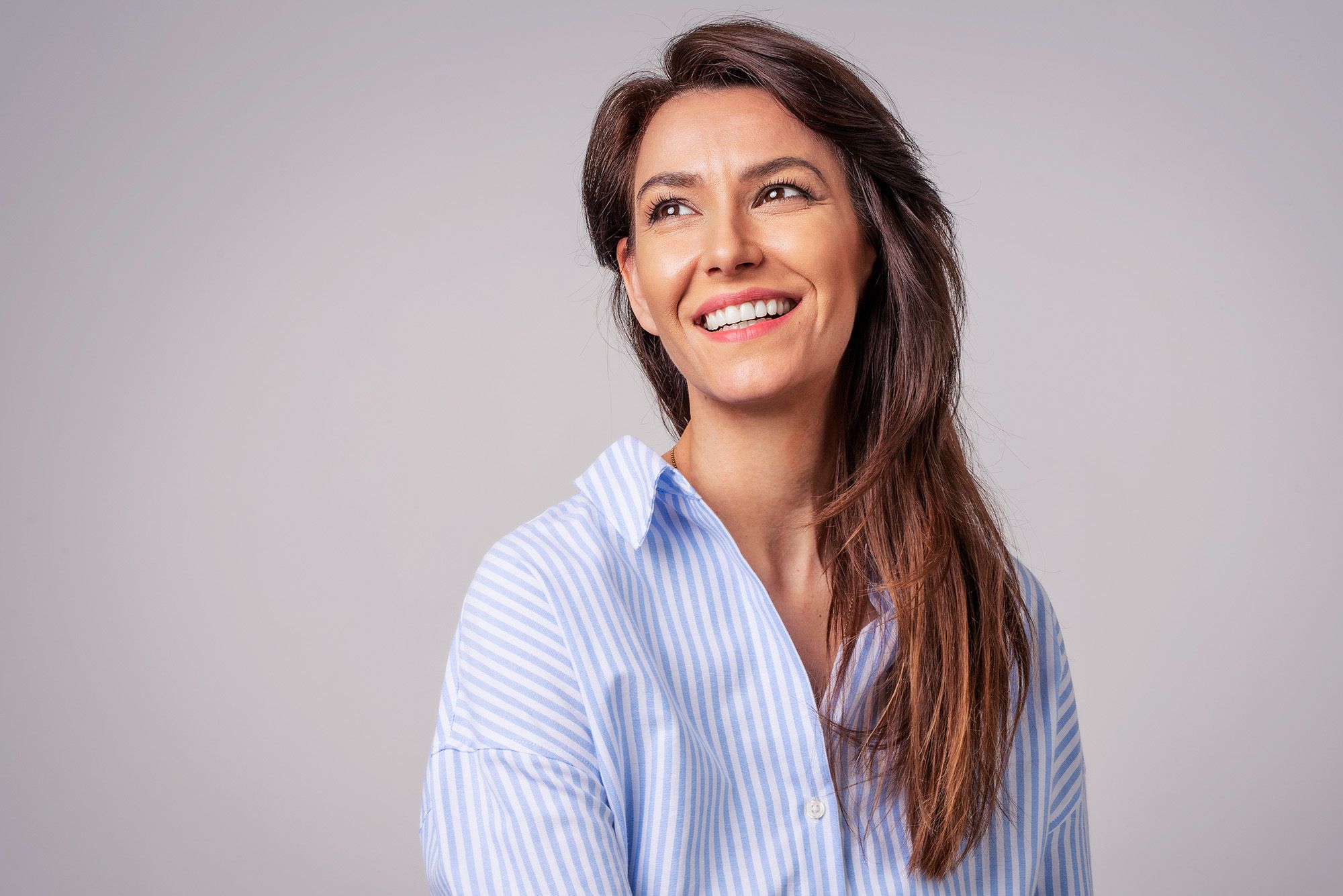 Stock image of female posing showing her white teeth.