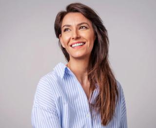 Stock image of female posing showing her white teeth.