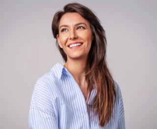 Stock image of female posing showing her white teeth.