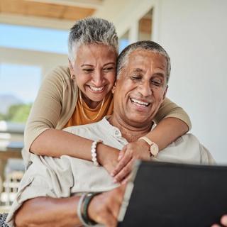 Image of a elderly couple discussing which dental treatment they should proceed with at their home.