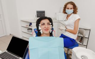 A patient undergoing TENS therapy with her dentist.