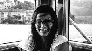 A black and white image of a smiling woman