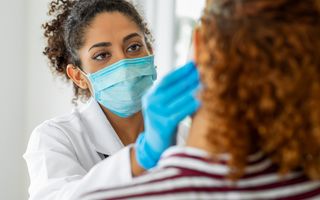 Dentist examining a patients mouth