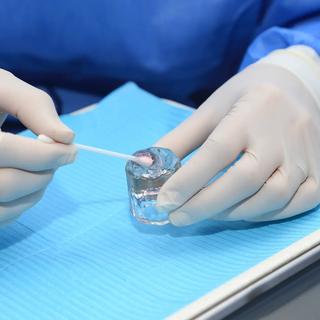 Dentist preparing fluoride treatment for patient