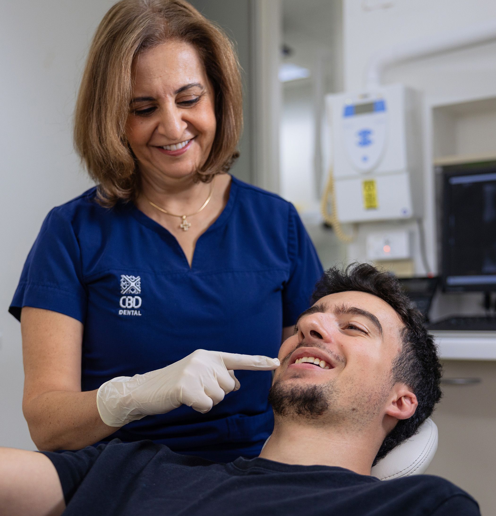 Image of Dr Nadine Samir with a young patient at her clinic.
