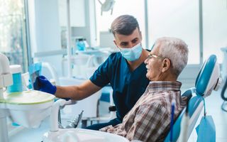 Dentist walking a patient through their x-ray