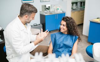 Dentist talking with patient post-treatment