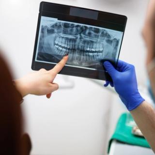A patient going over their dental x-rays with their dentist.