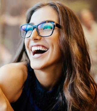 Stock image of female enjoying her mobile content with a white smile.
