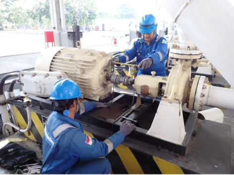 Two engineers working on a machine