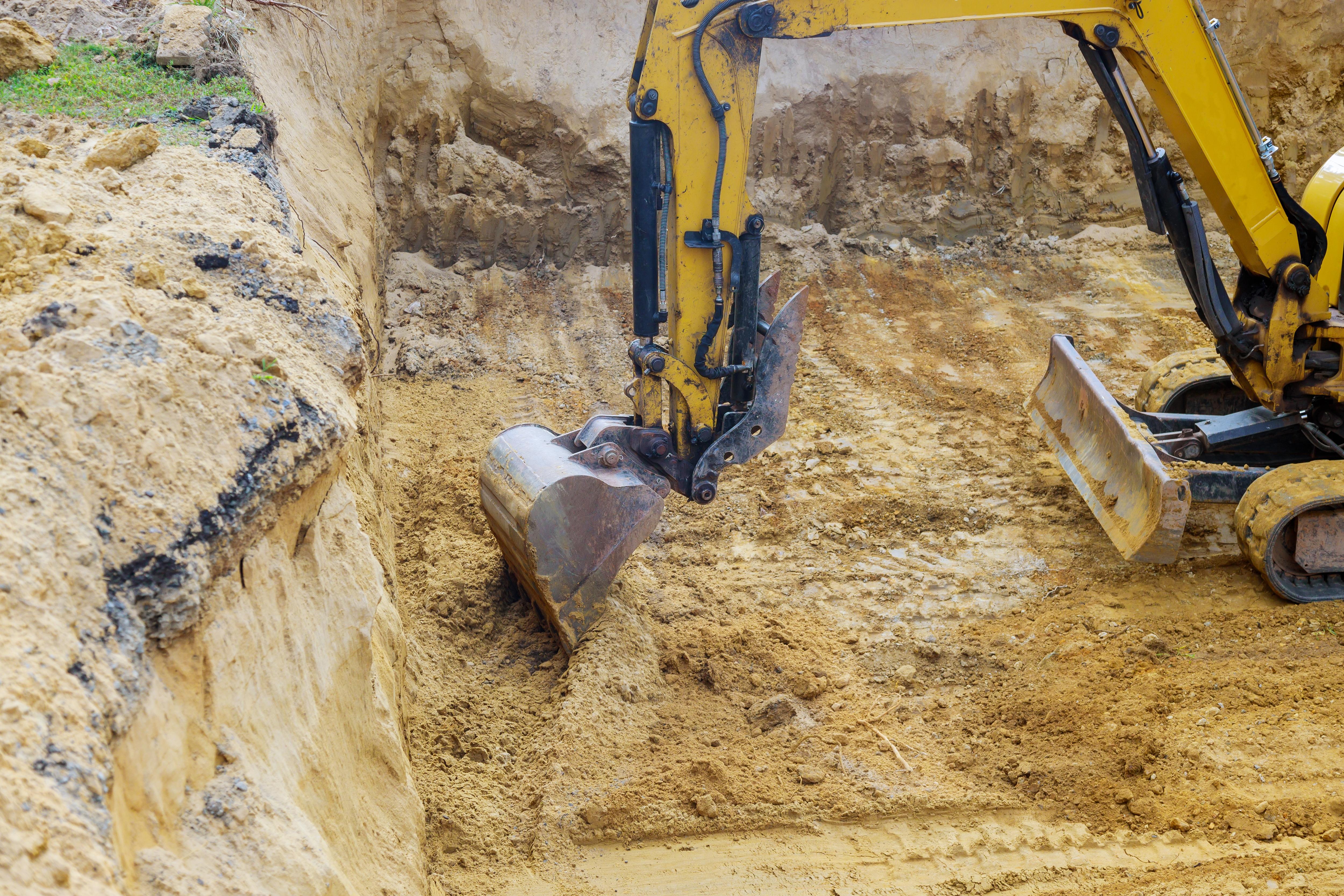 Excavator performing precision excavation and trenching for site preparation at a construction project in Sydney, NSW.