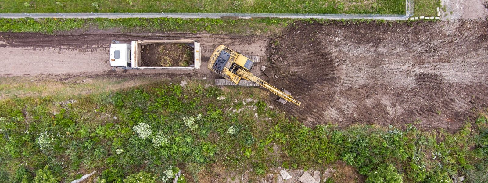 Professional land clearing services in Sydney with excavator removing vegetation and preparing a development site.