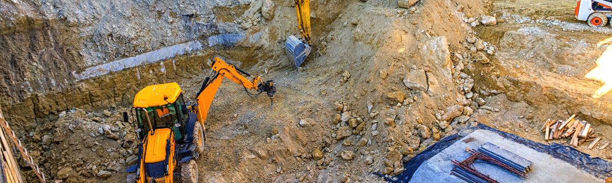 Excavator and earthmoving equipment performing professional excavation services at a construction site in Sydney, NSW.
