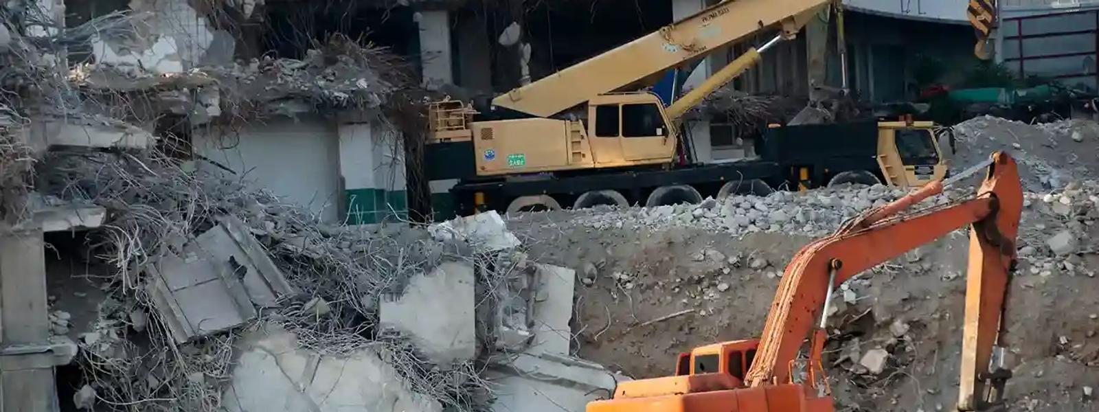 Hydraulic breaker demolishing reinforced concrete and steel rebar during a commercial demolition project in Sydney, NSW.