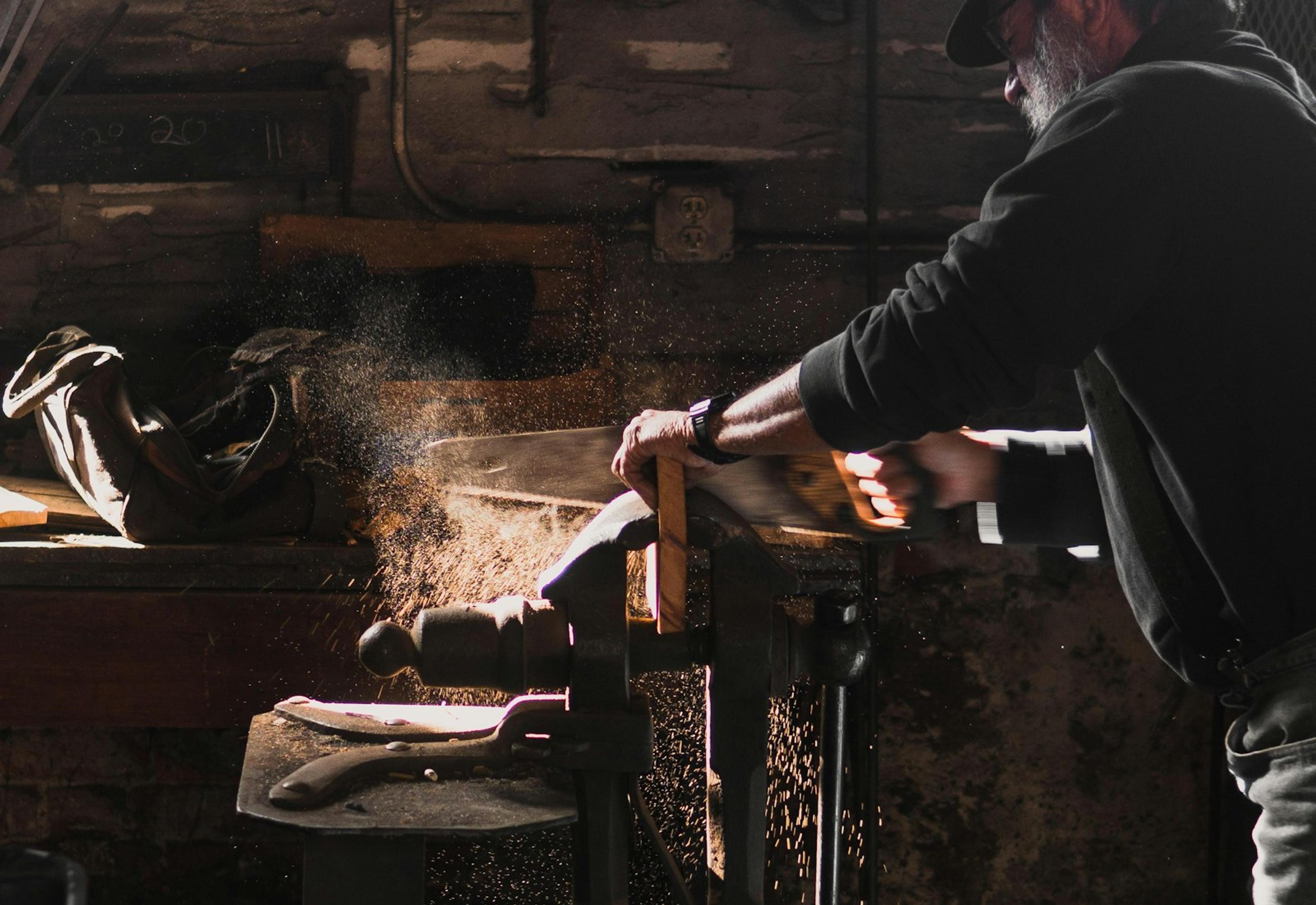 Carpenter cutting timber in the workshop