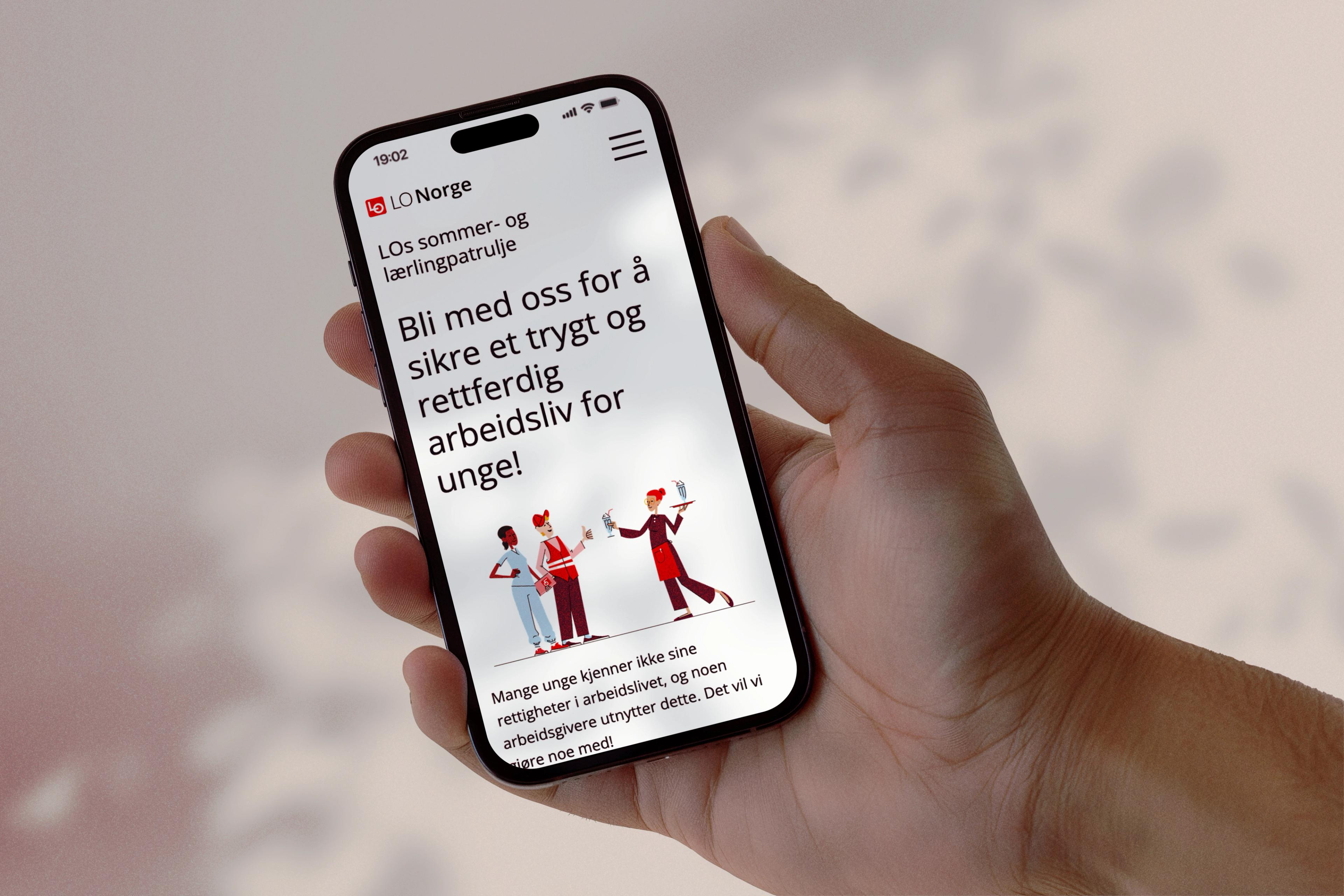 Hand holding smartphone outdoors. Text on screen: "Join us to ensure a safe and fair working life for young people".