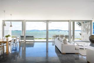 modern coastal living room with wall-to-wall windows