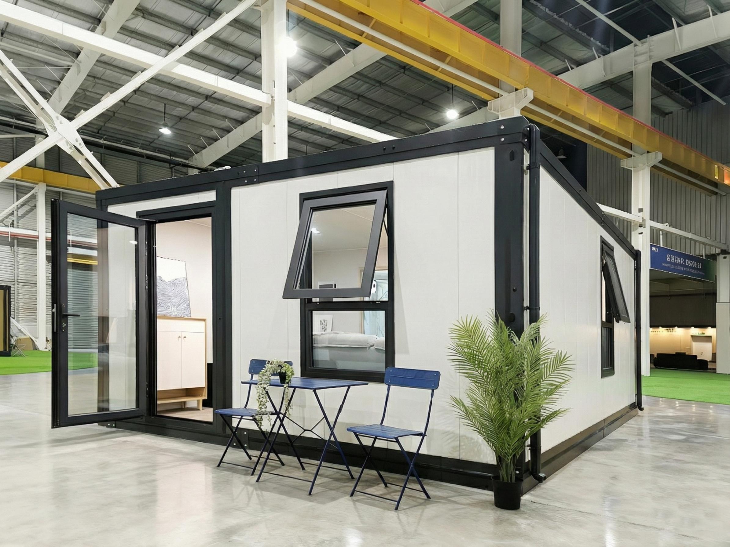 The PrefabX Studio seen from outside, a compact single storey building with full height glazing