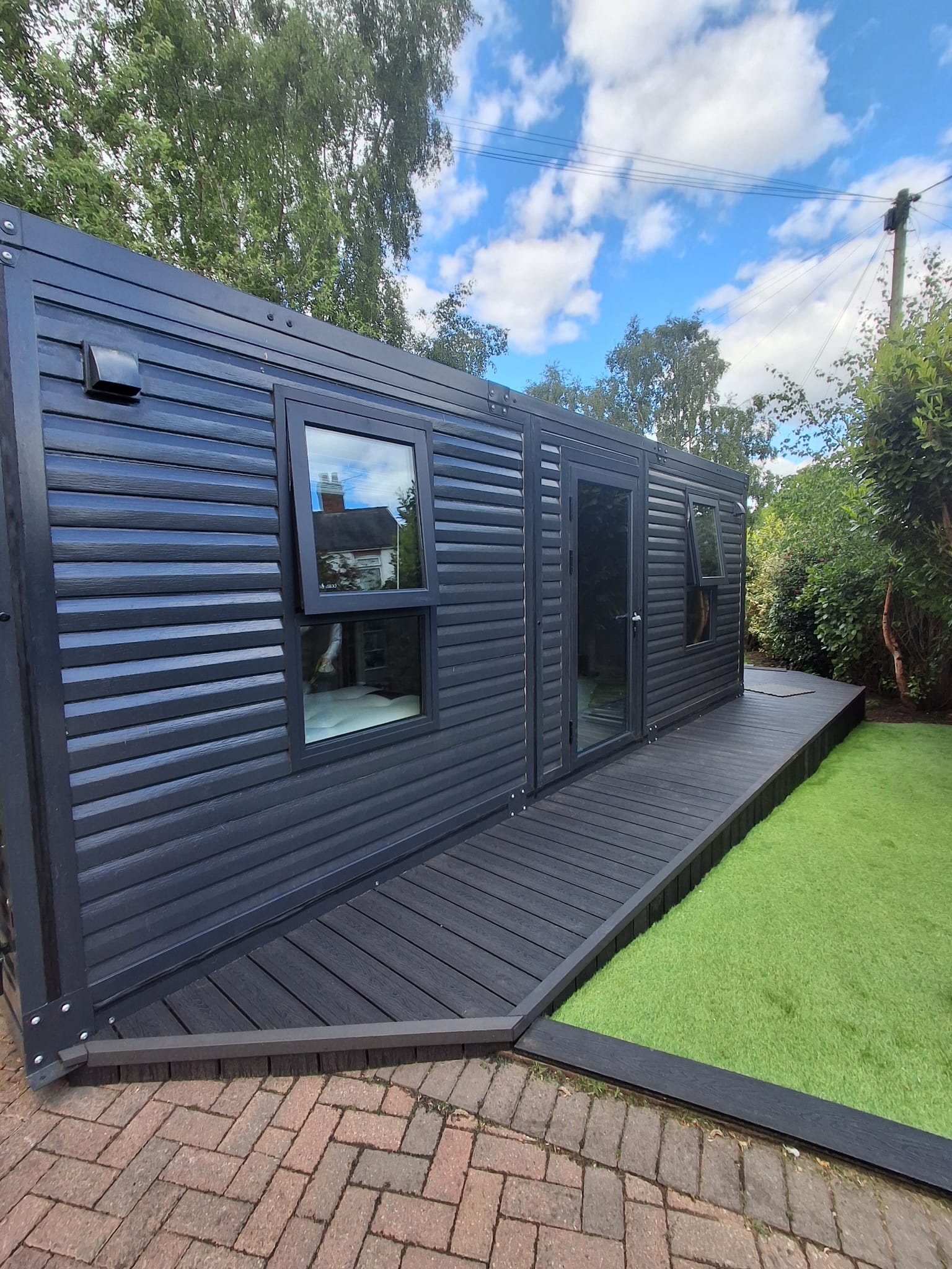 A garden office and studio at the end of the lawn, Cheshire, built with the PrefabX Studio