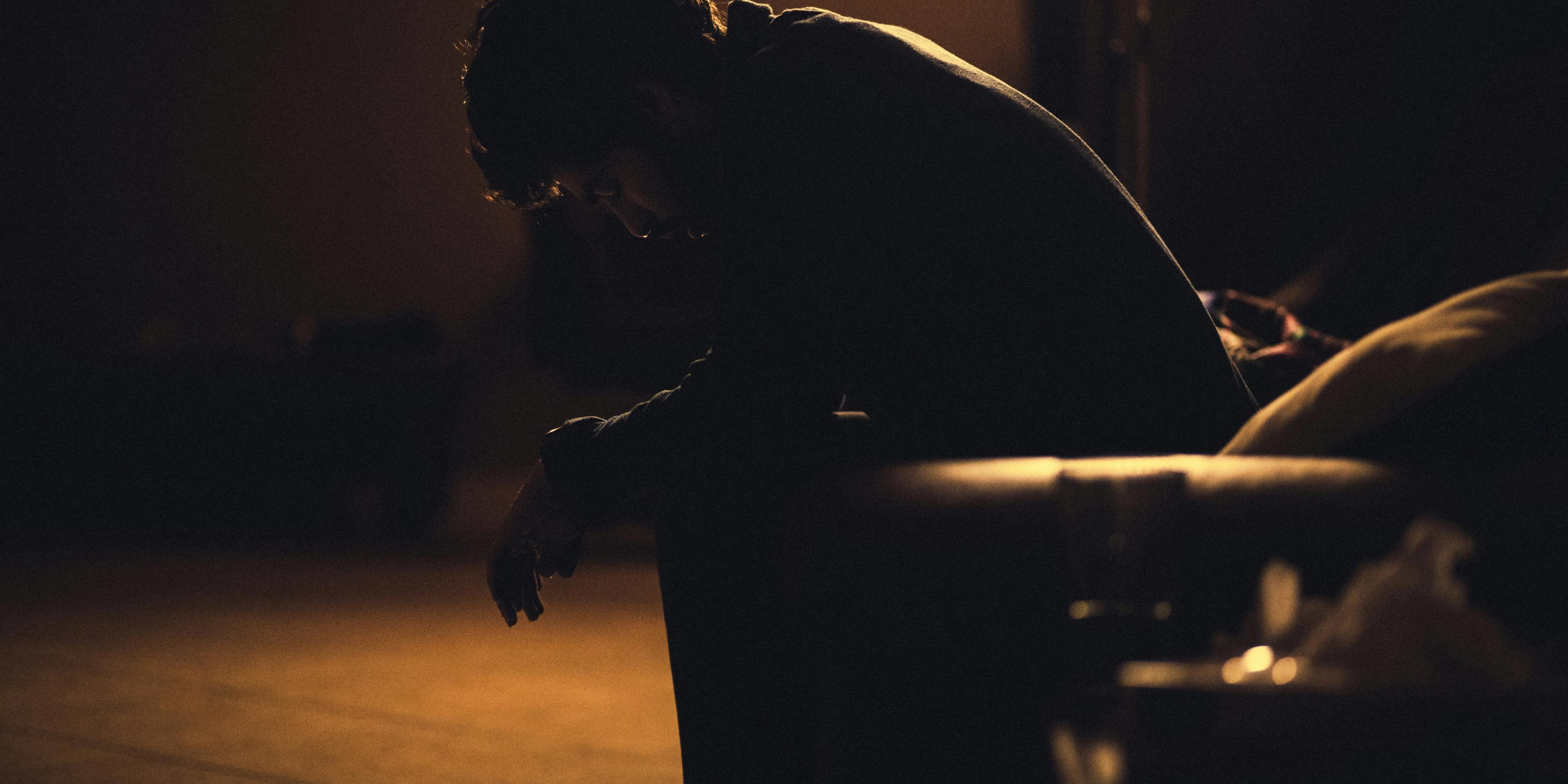 A man on a dark side of the street