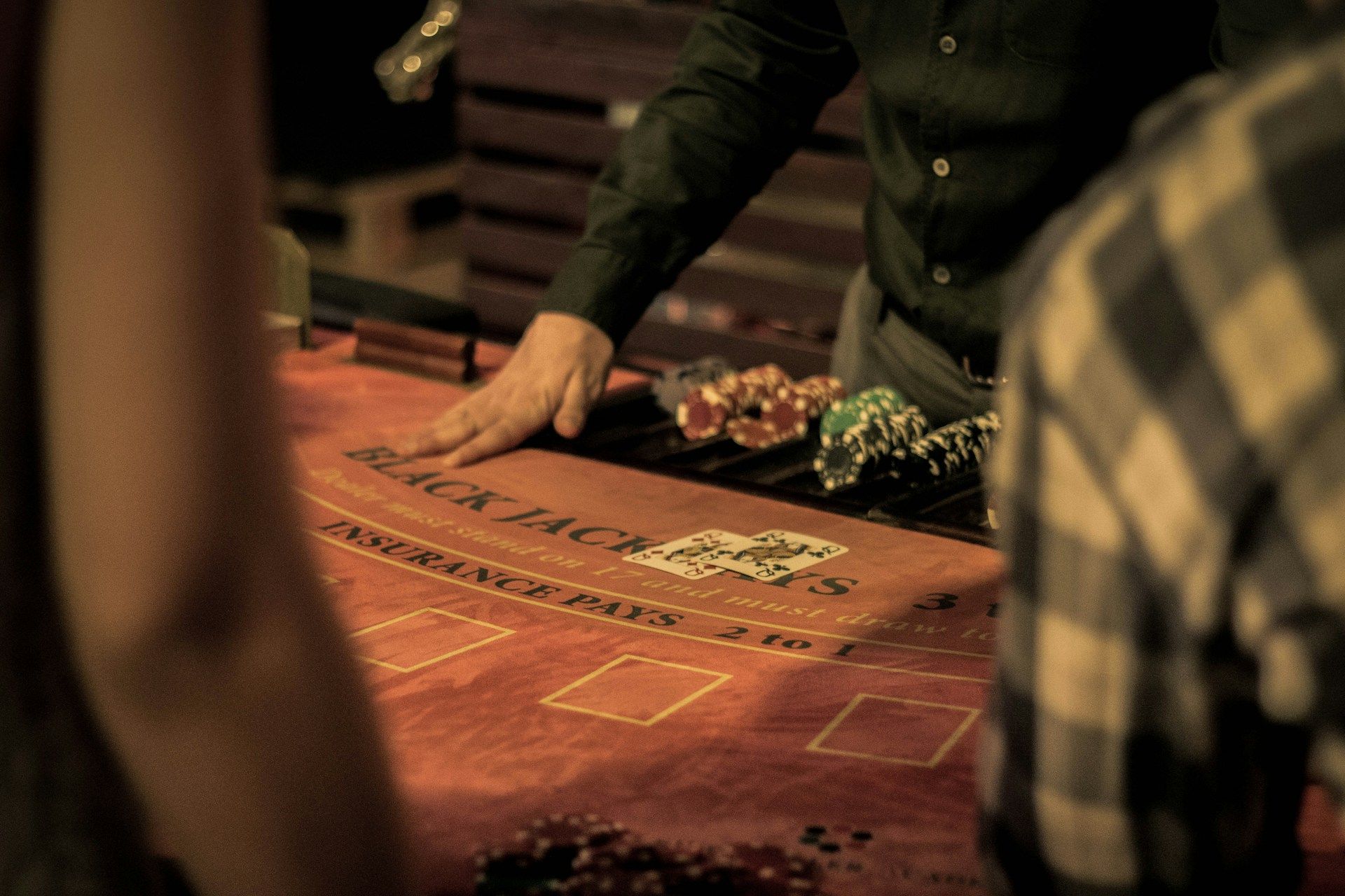 A person plays card at a casino table