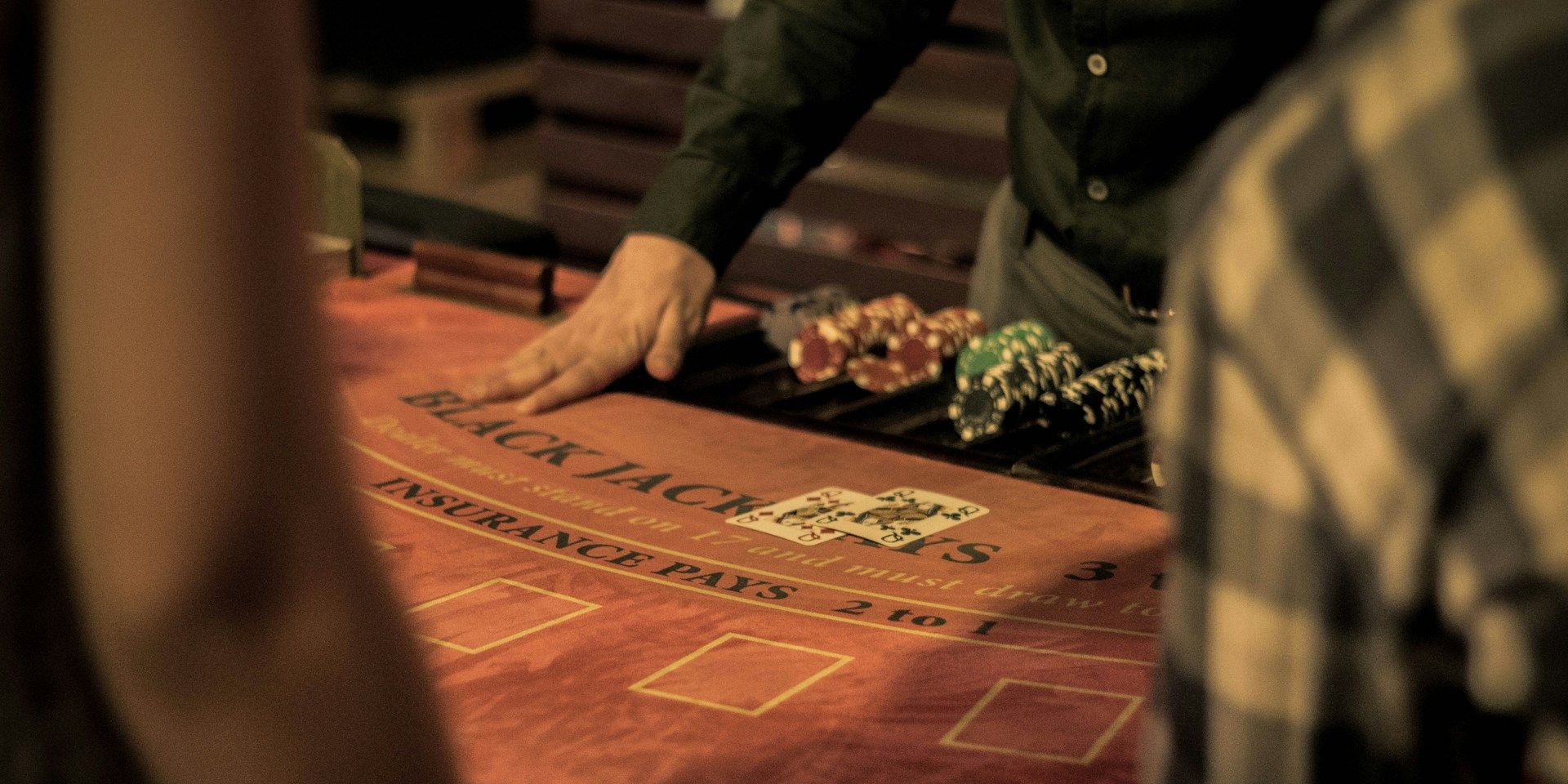 A person plays card at a casino table