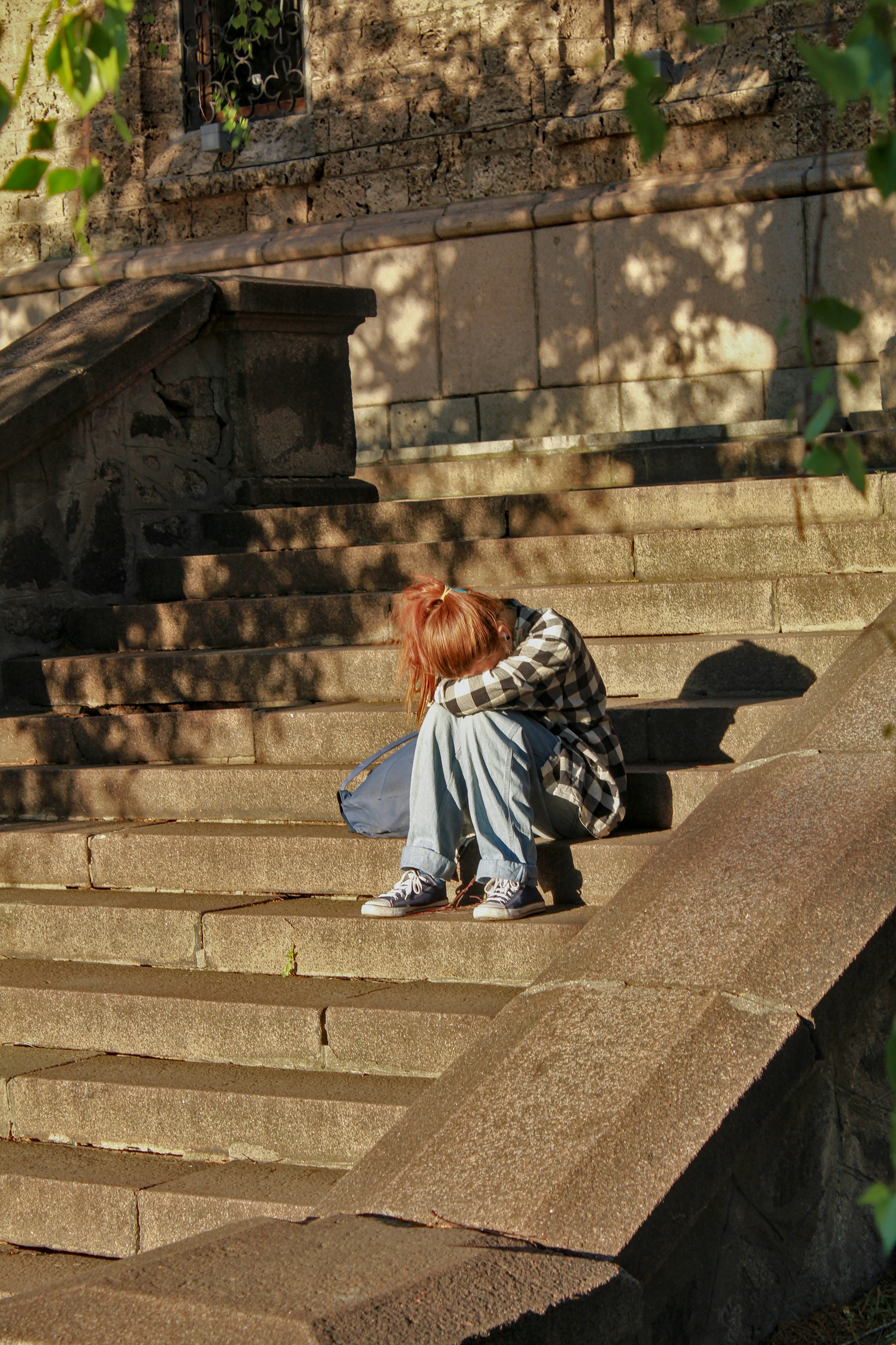 A person sitting on a set of stairs