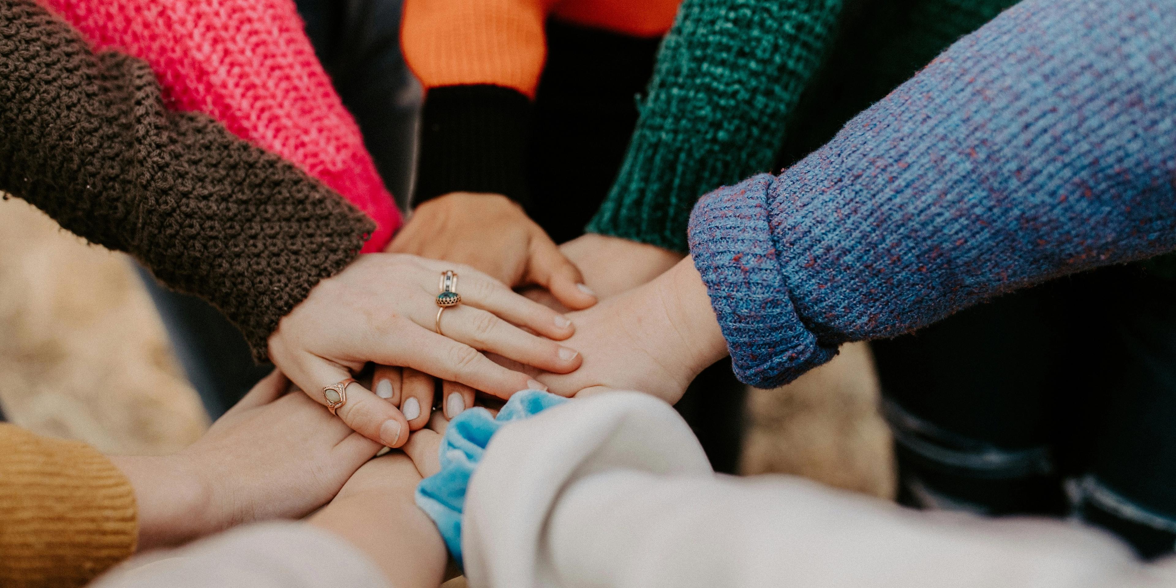 Group of people putting hands
