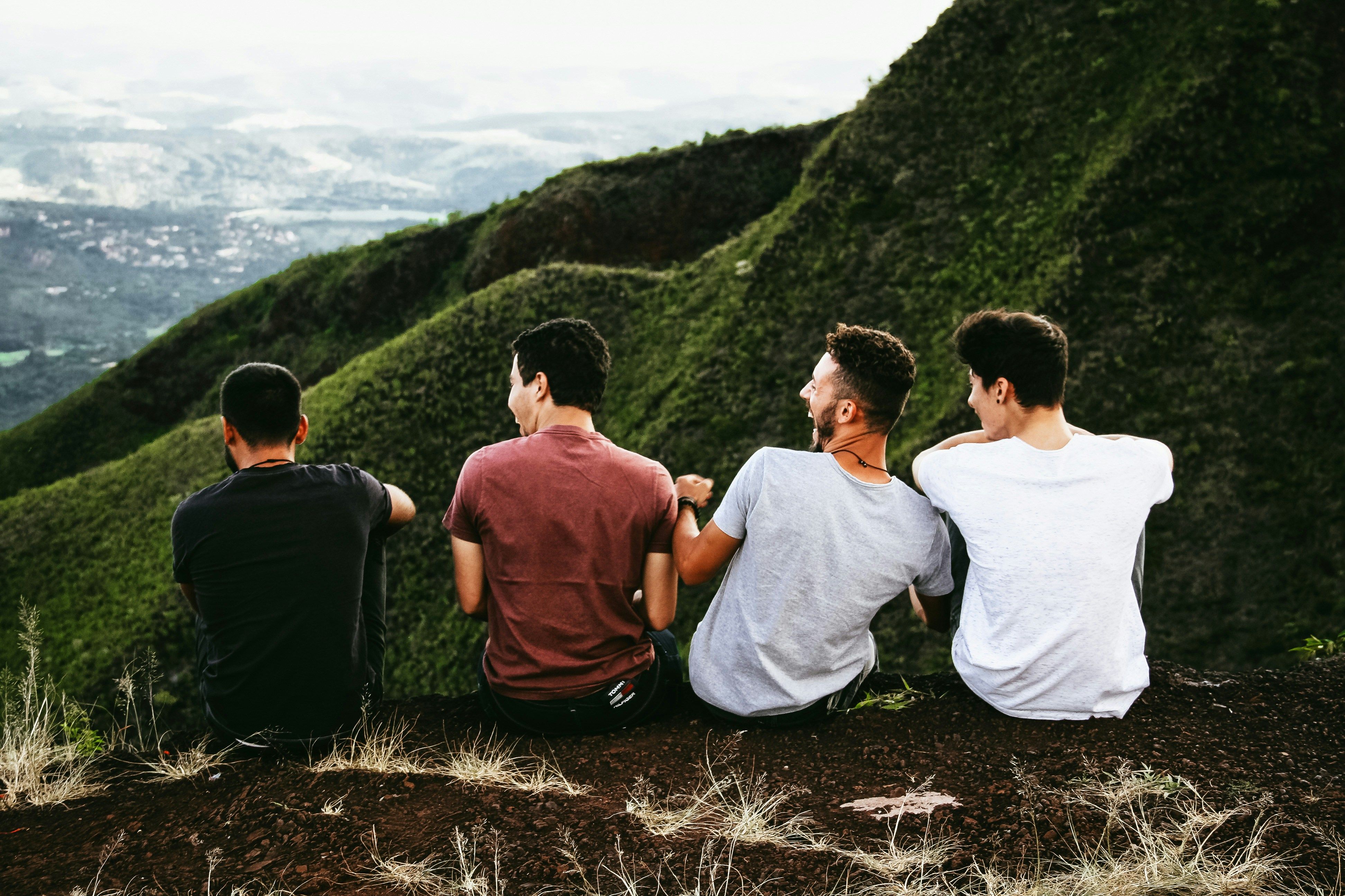 Group of friends sitting on a mountain