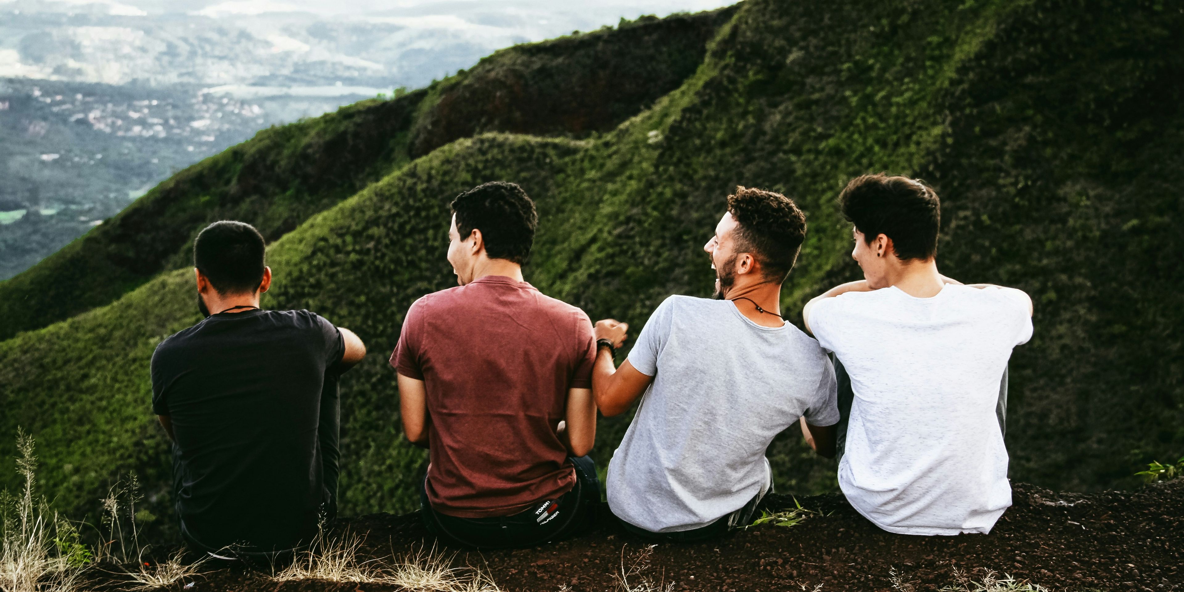Group of friends sitting on a mountain