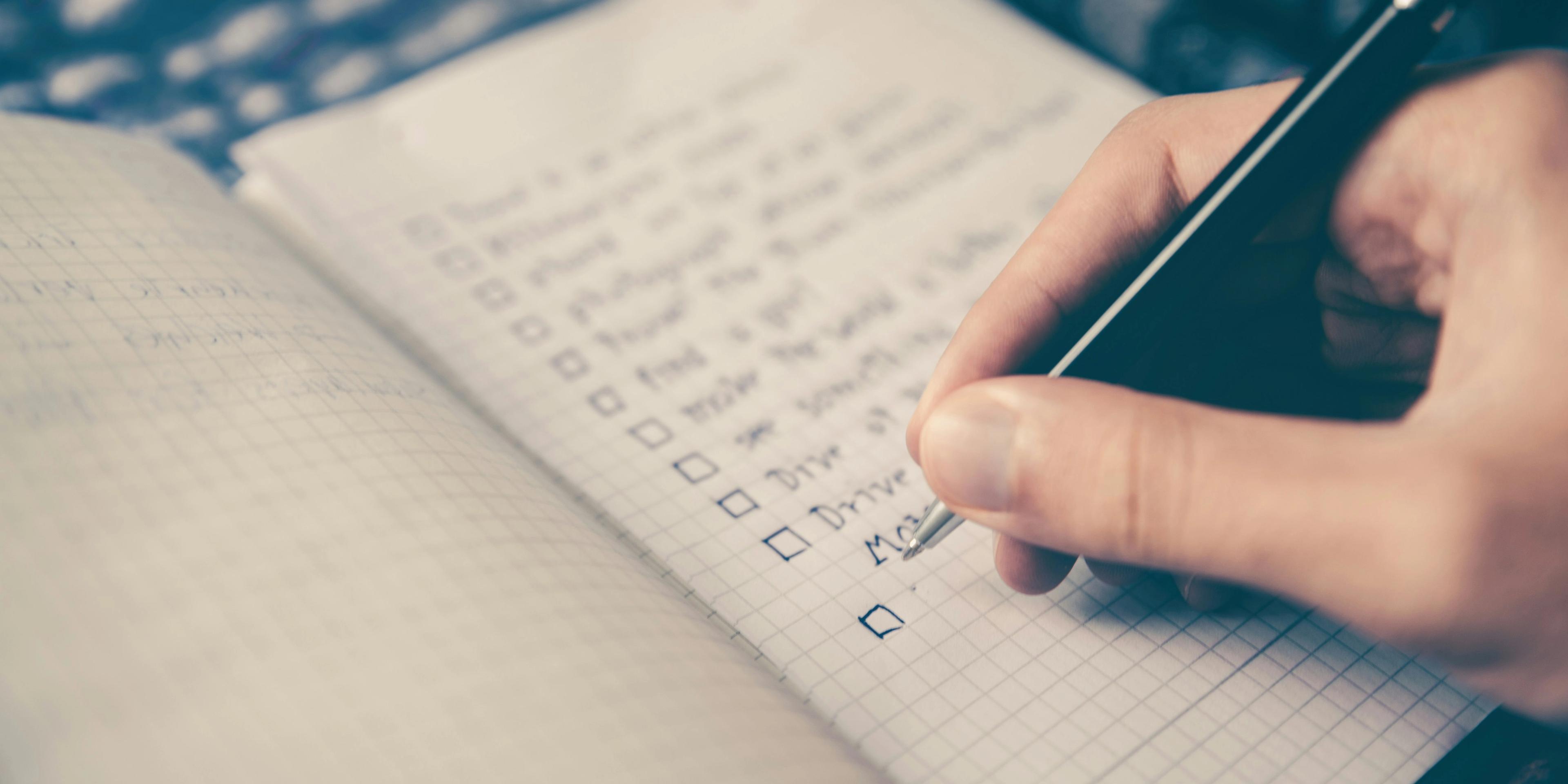 A person writing a checklist