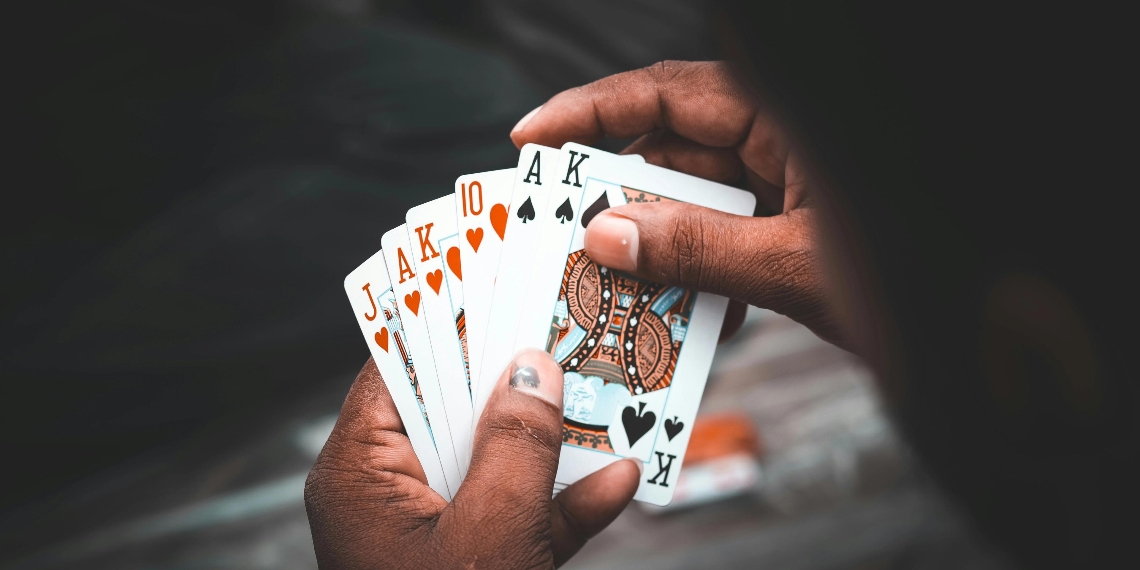 A person holding a bunch of cards