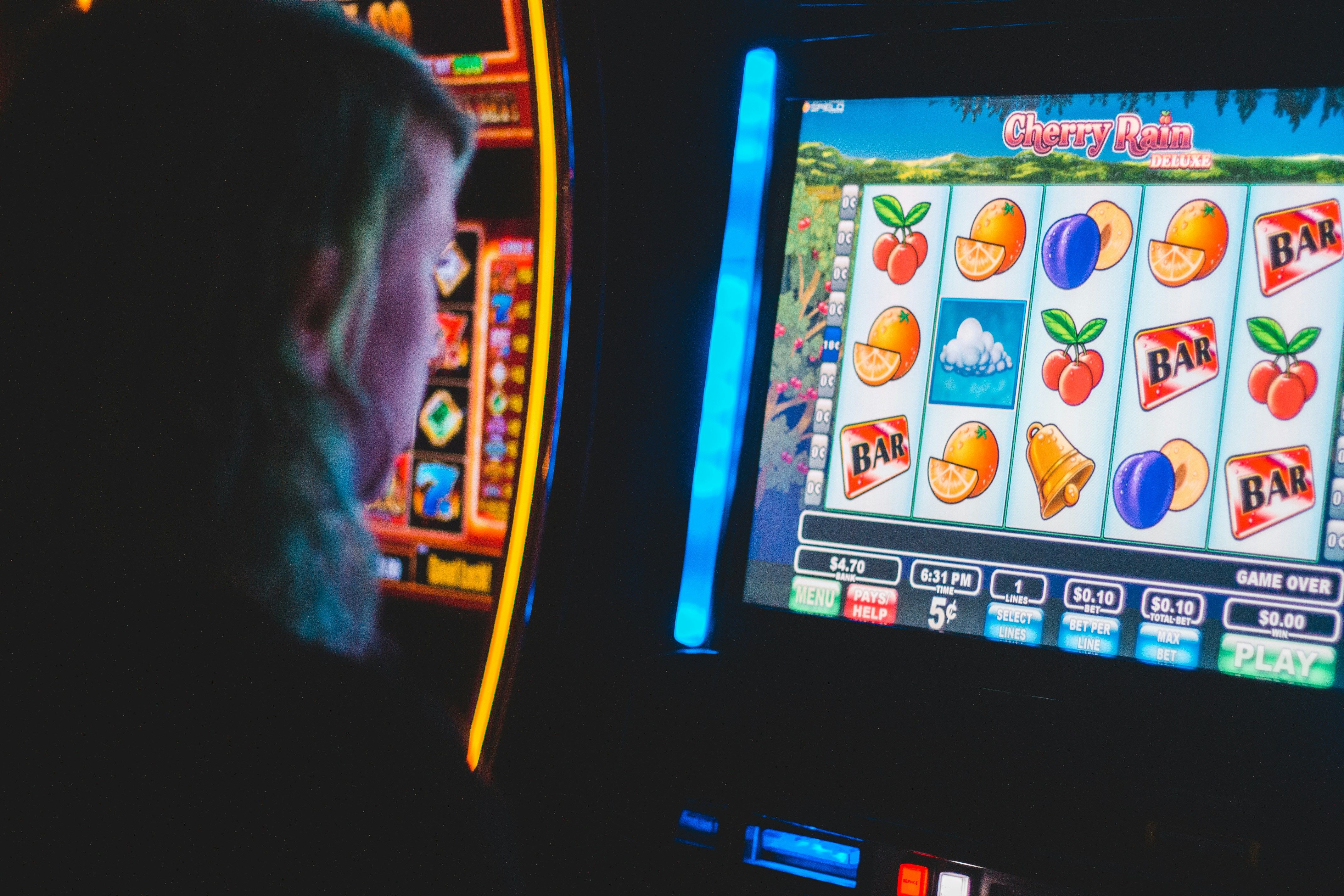 A person playing on a slot machine