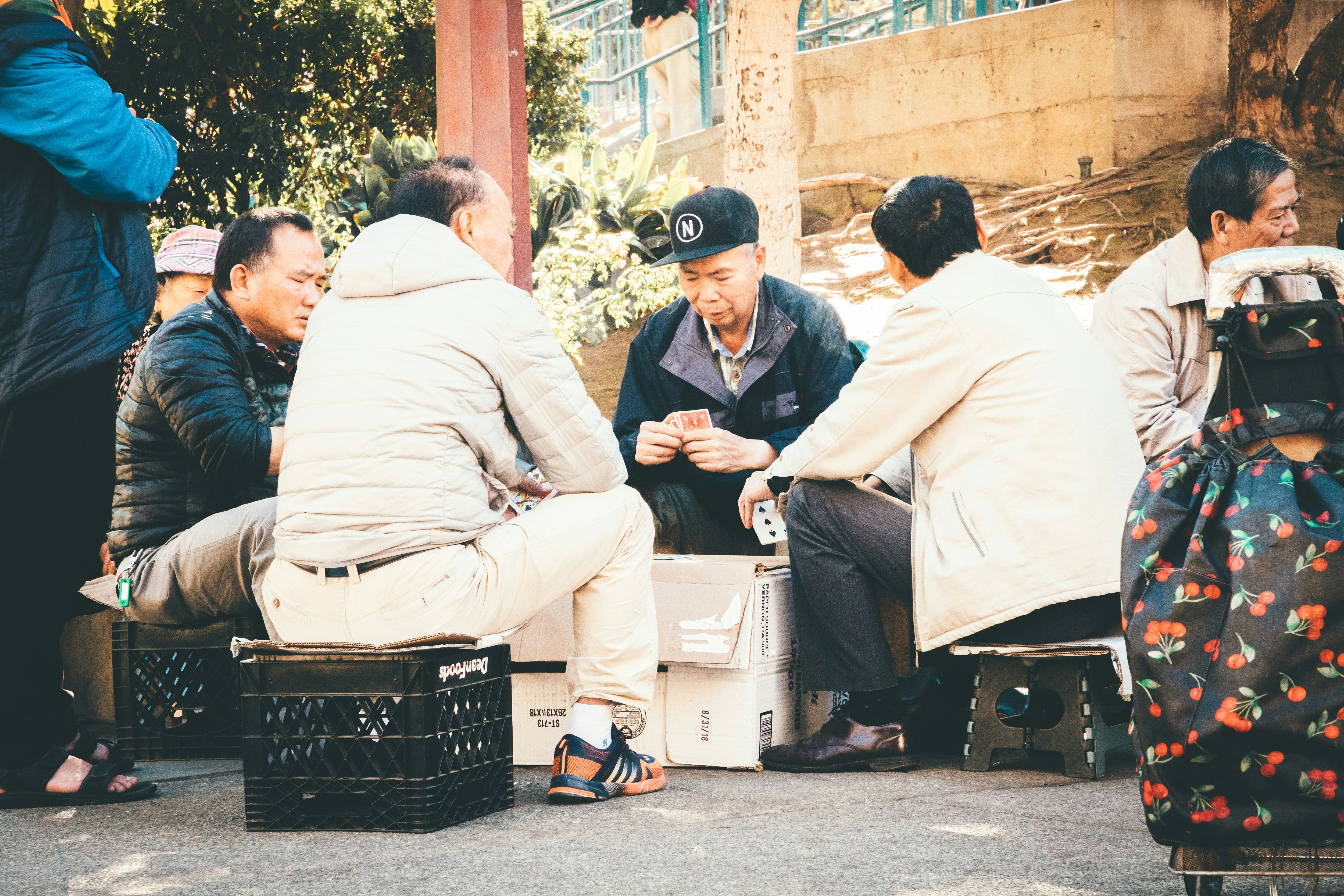 Group of people sitting and gambling