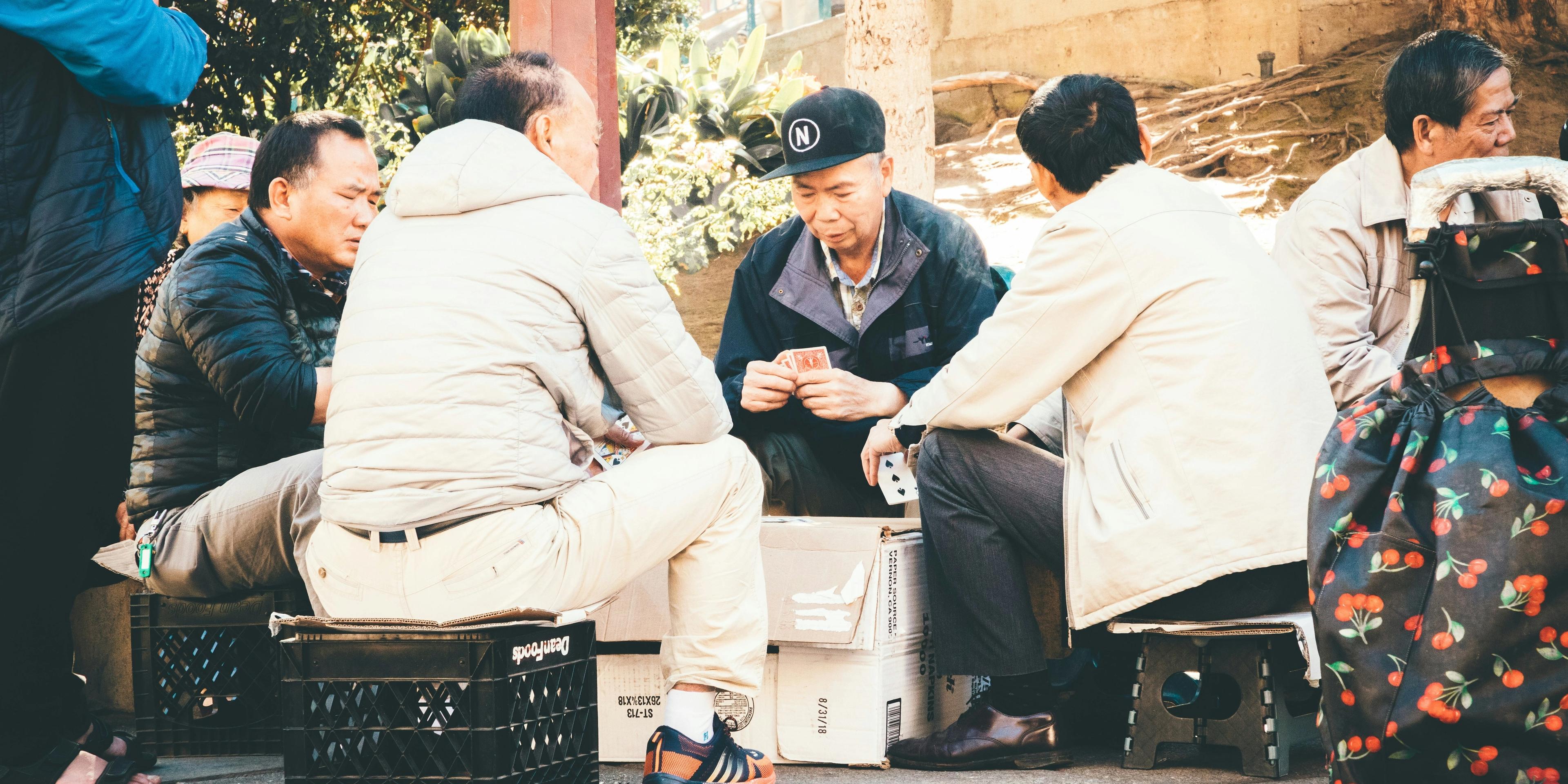 Group of people sitting and gambling