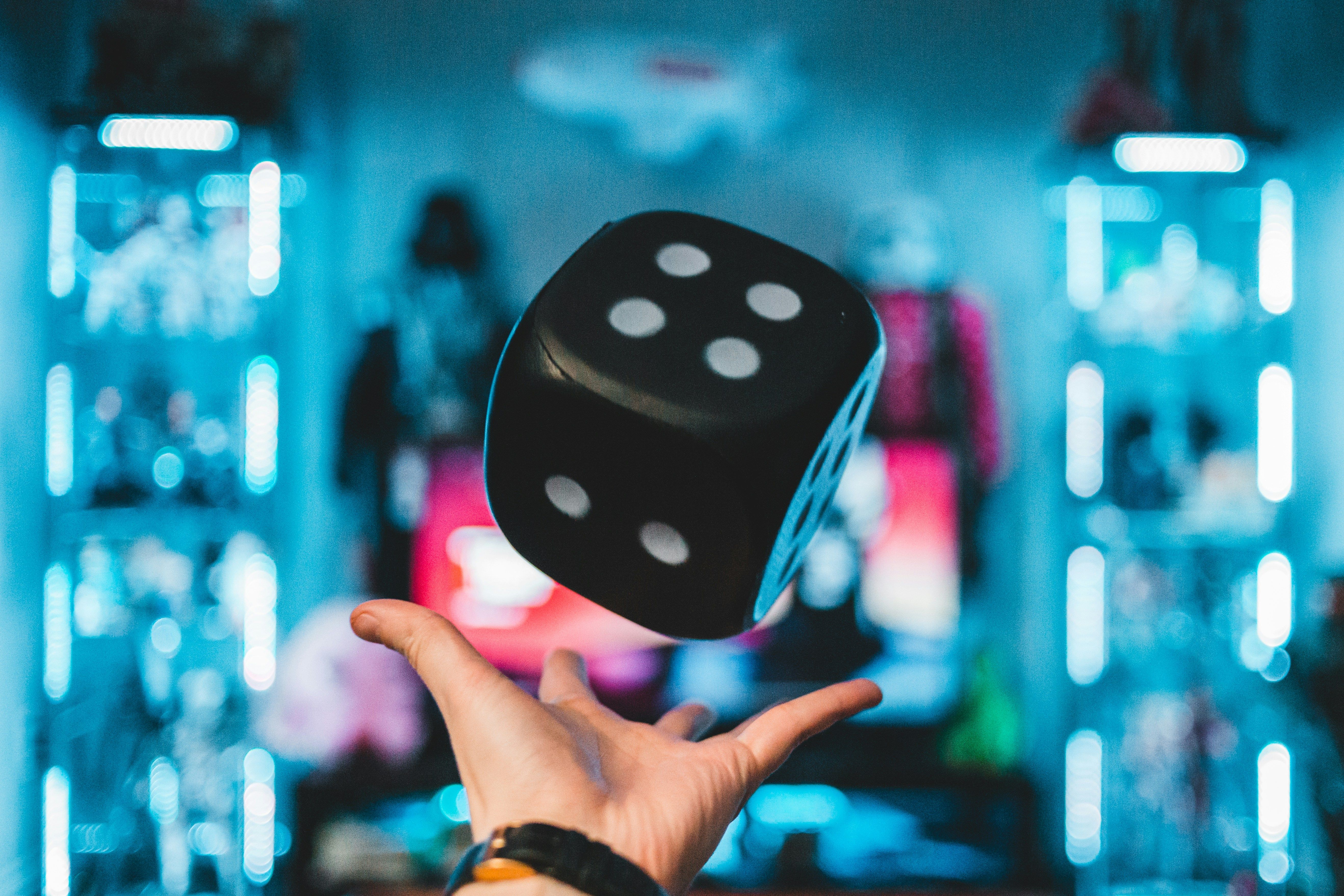 A guy holding a big die