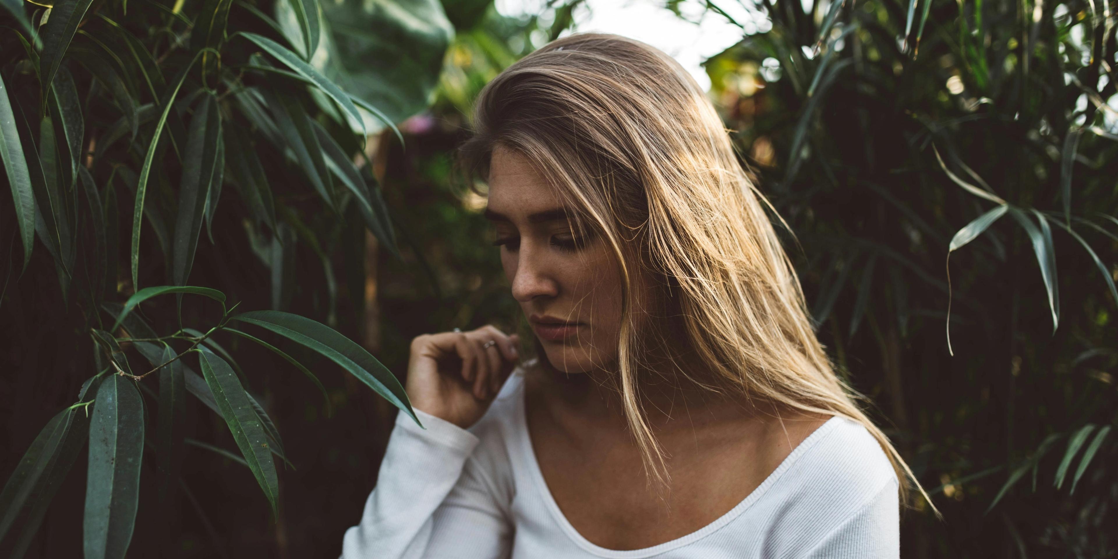 A person surrounded by leaves