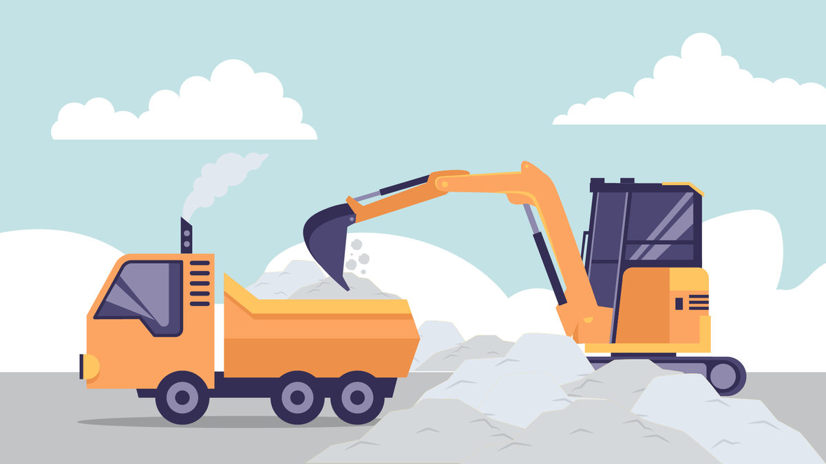 An excavator loading up a dump truck with sand & gravel.