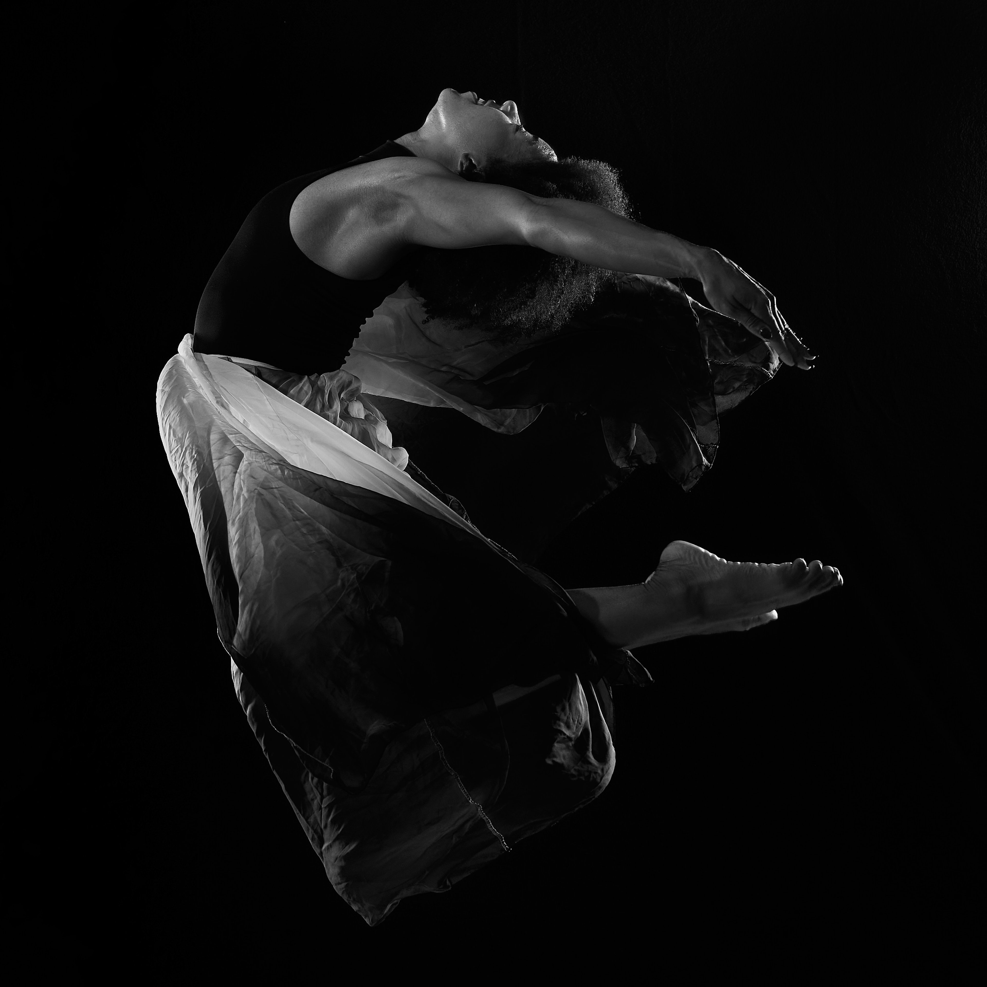 The Kinetic Arc — a black and white dancer study on pure black