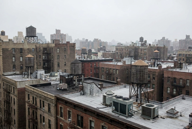 Upper East Side Manhattan rooftops with cooling towers and HVAC units against the skyline.