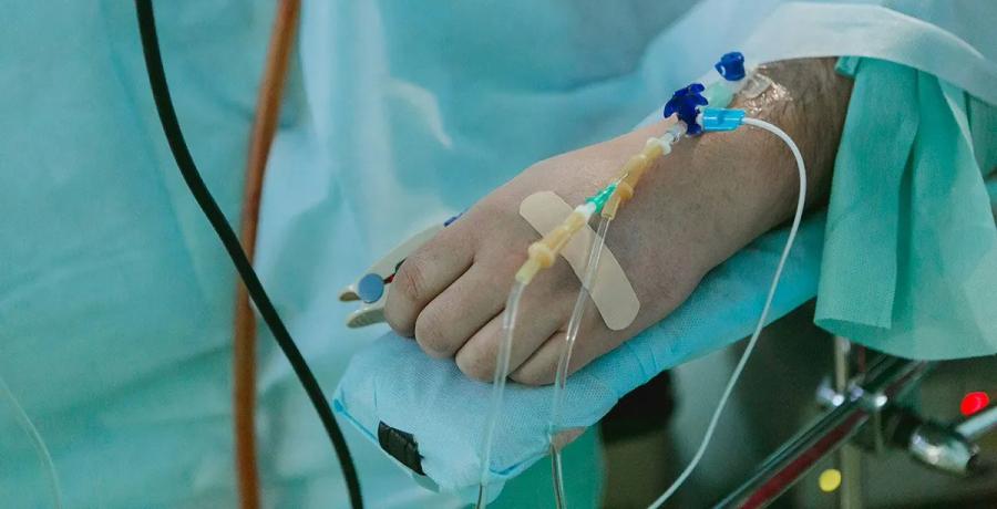 Patient's hand with intravenous lines during a surgical procedure