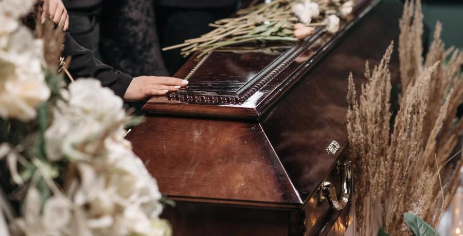 a person holding a wooden coffin