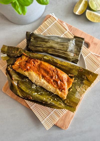 Fertige guatemaltekische Tamales in Bananenblättern mit Recado-Rojo-Füllung.