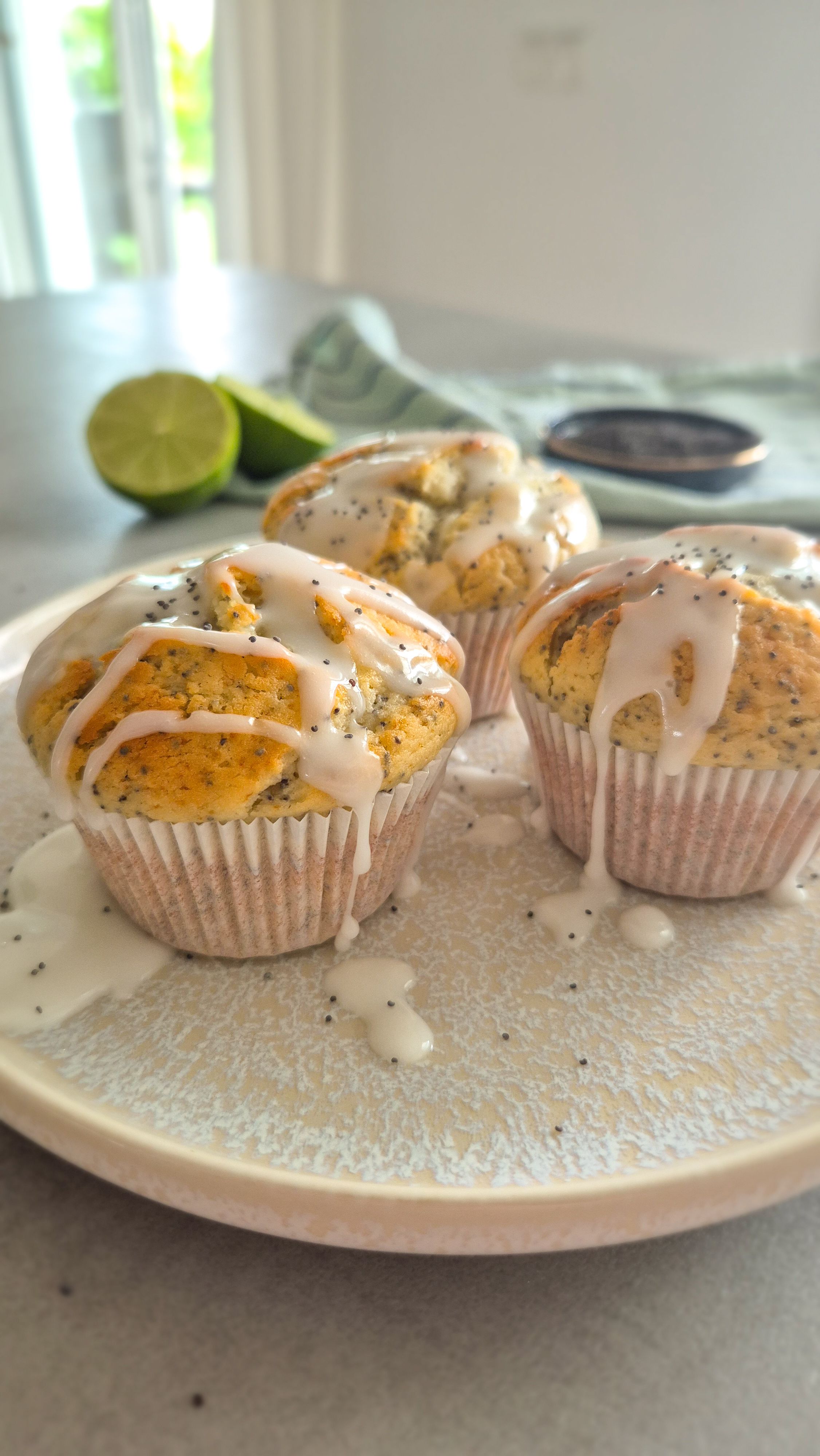 Saftige Zitronen-Mohn-Muffins mit Skyr und Zitronenglasur auf einem Teller.