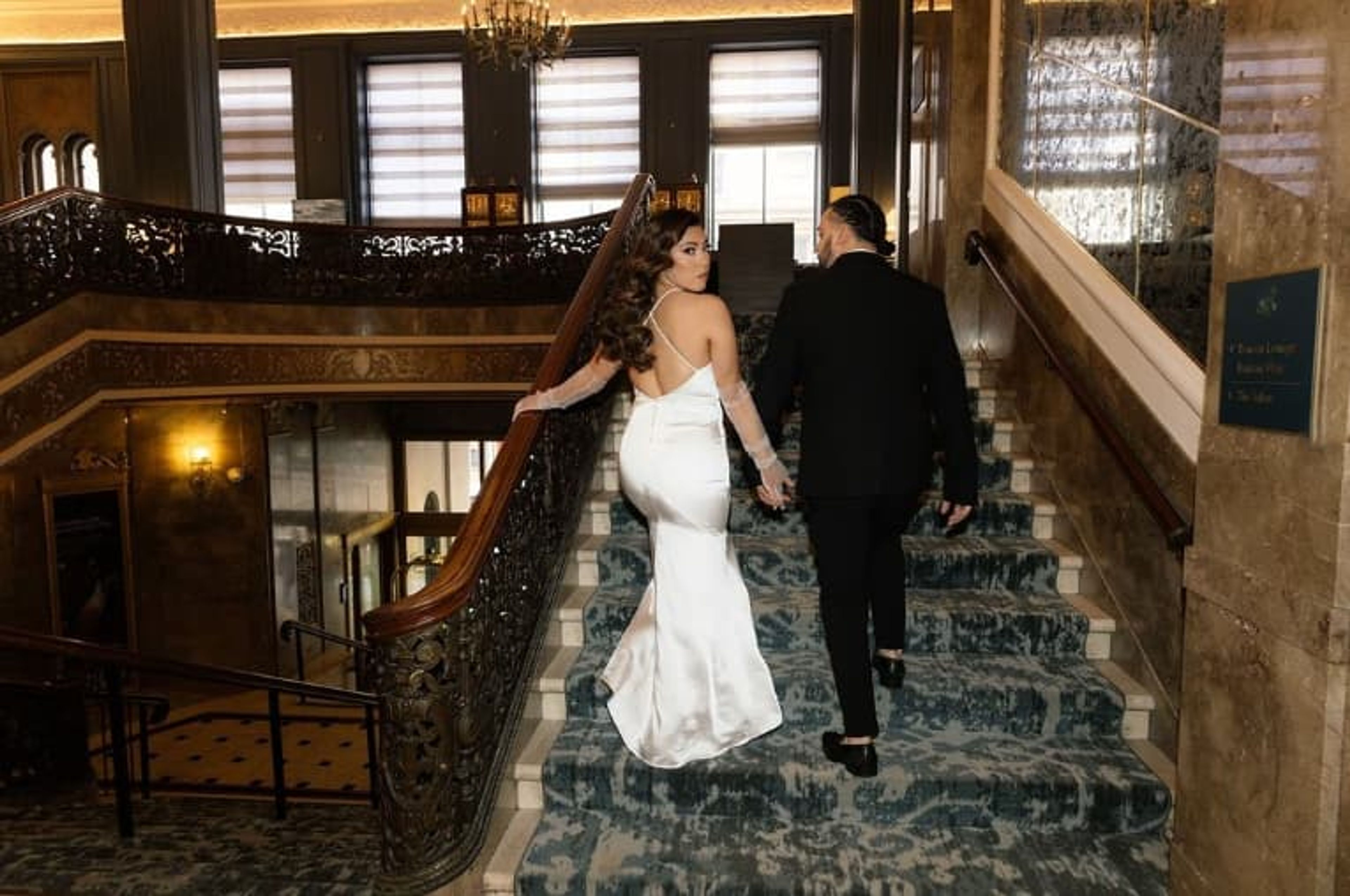 bride and groom on grand staircase.