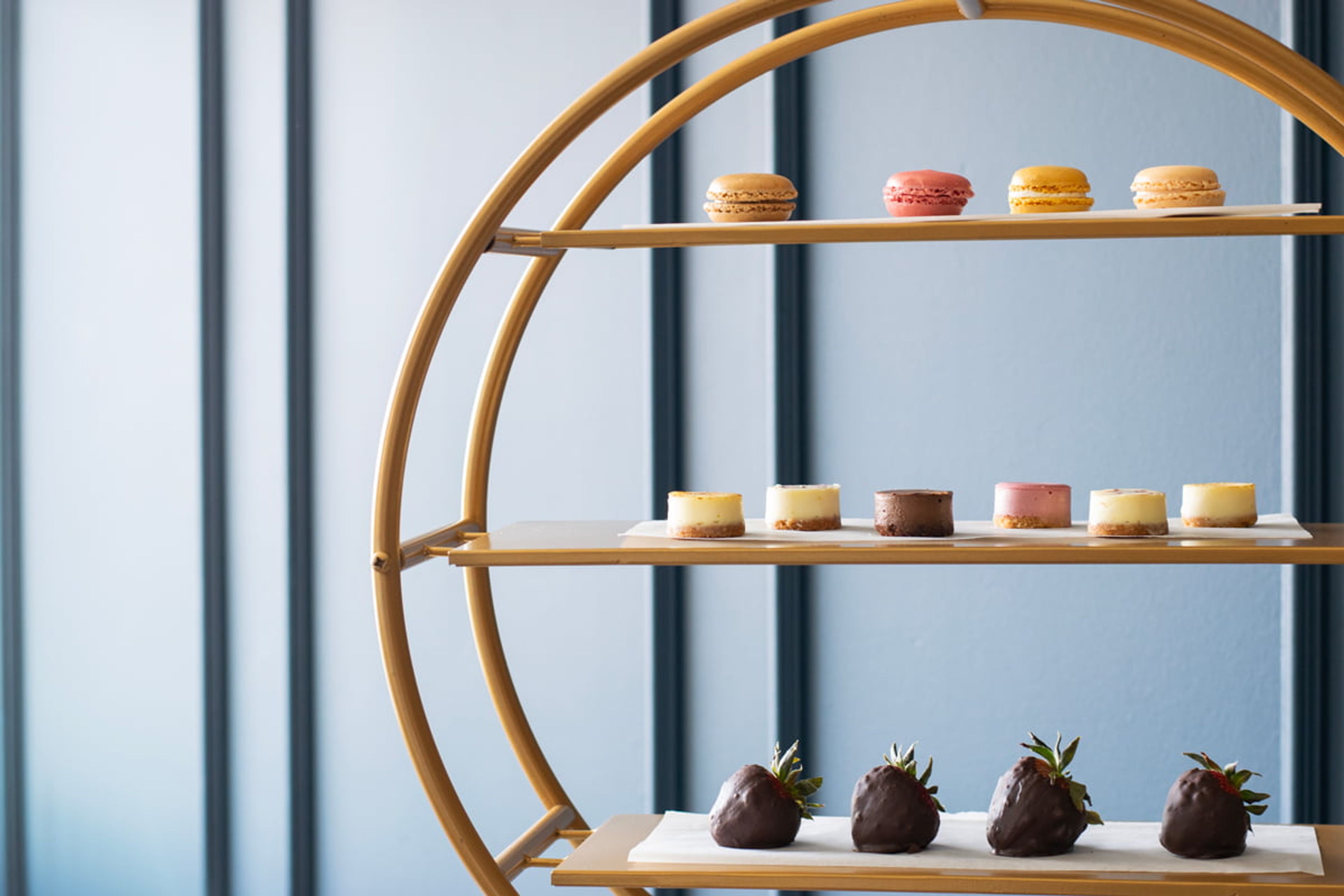 tray displaying mini chocolate covered strawberries and treats